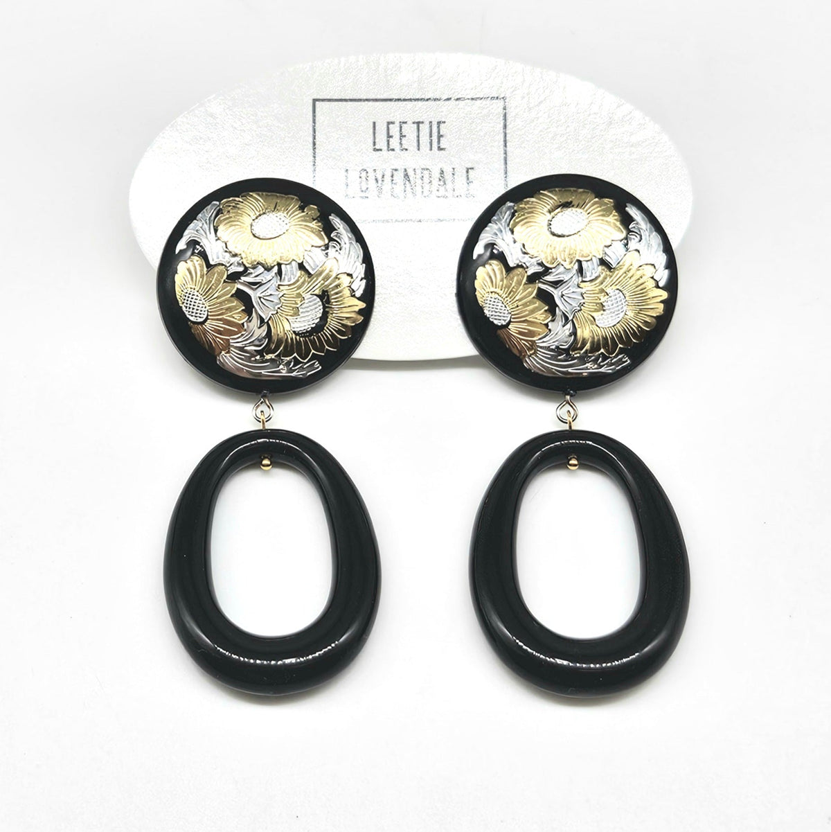 Black and gold floral earrings on a white background with 'Leetie Lavendale' branding.