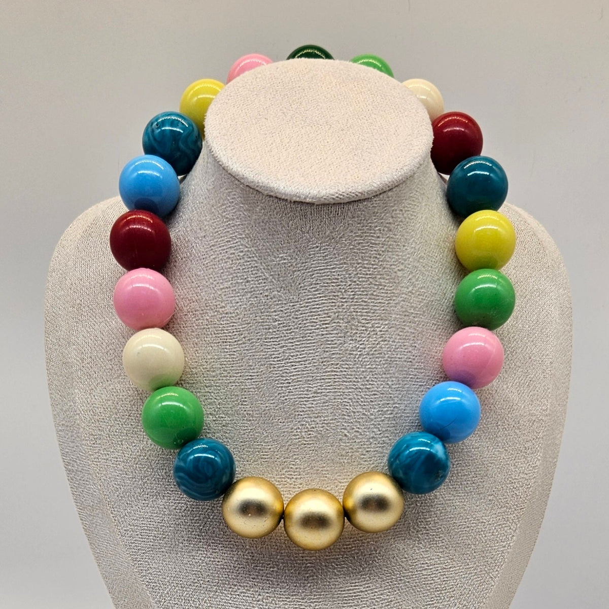 Colorful beaded necklace on a white bust