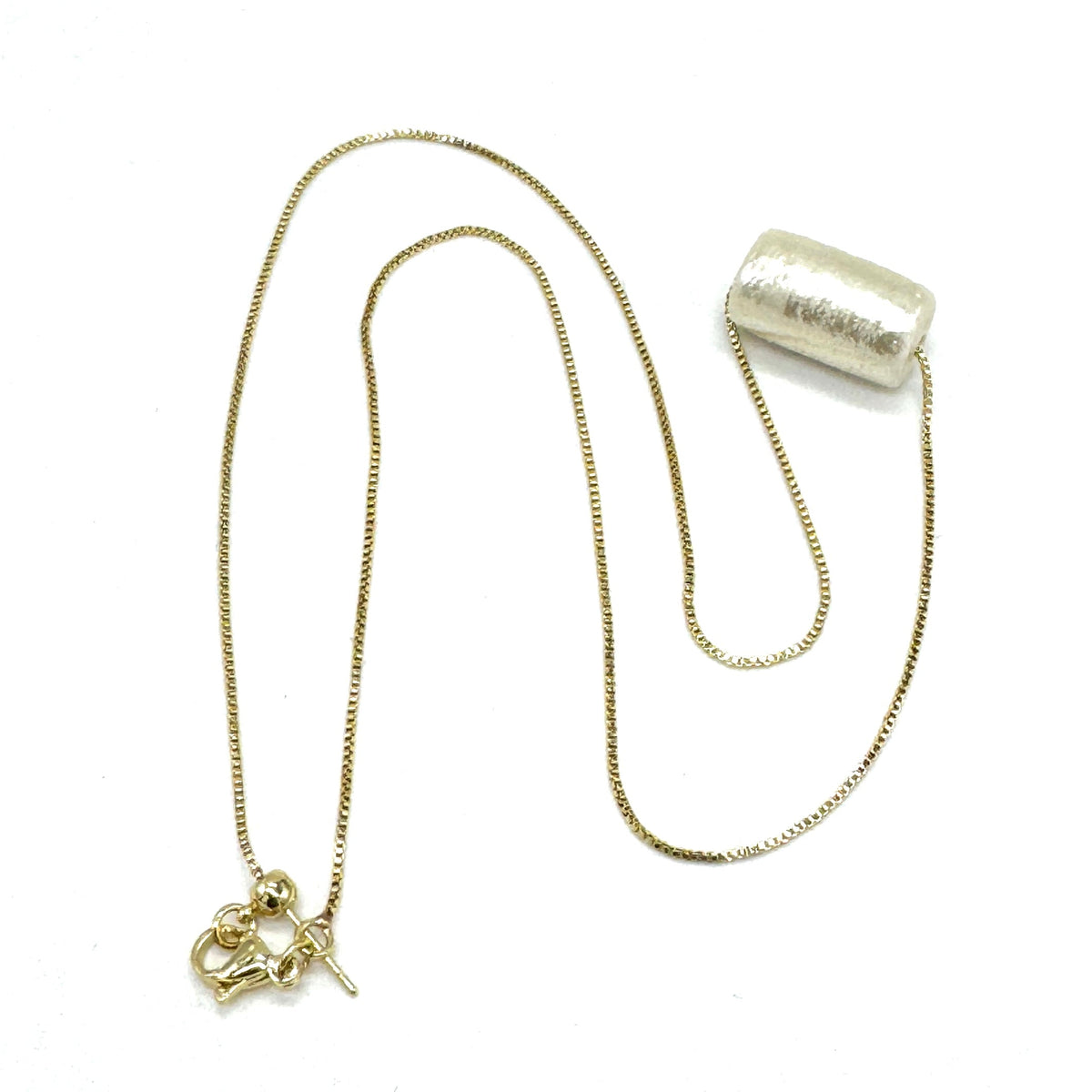 Gold necklace with a pendant on a white background
