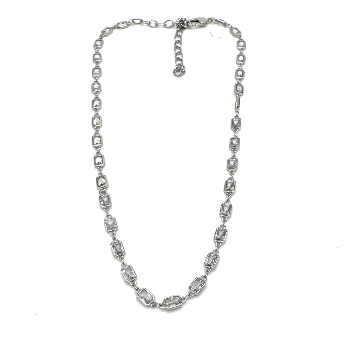 Silver necklace with clear stones on a white background