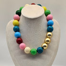 Colorful beaded necklace on a gray bust