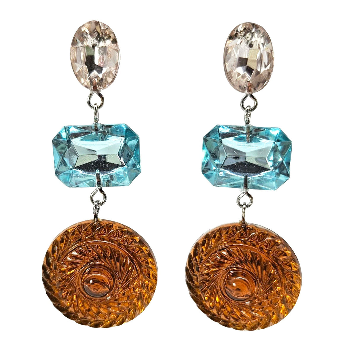 Pair of earrings with blue and orange gems on a white background