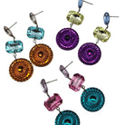 Colorful earrings with various shapes and patterns on a white background
