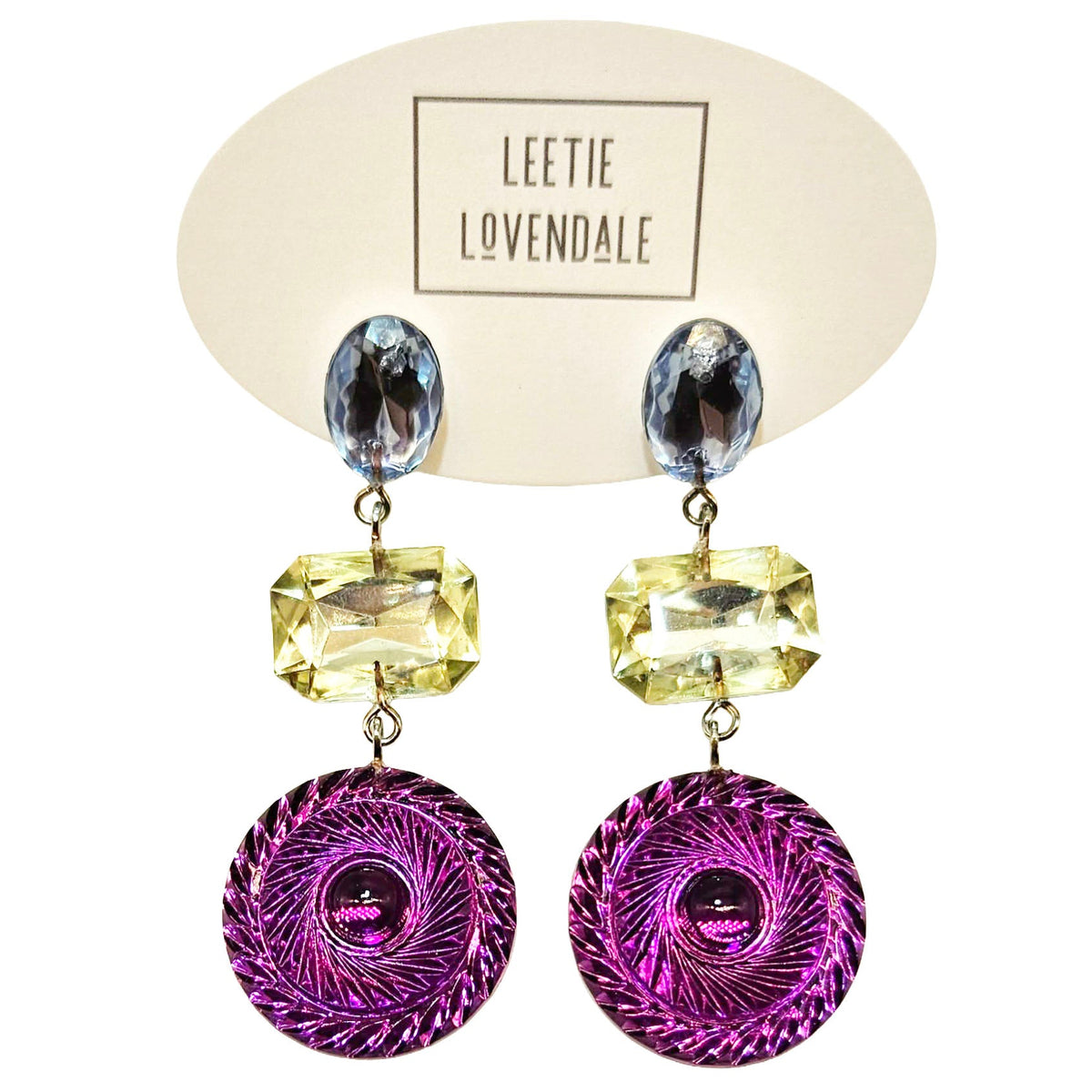 Colorful earrings with purple circular designs on a Leetie Lovendale branded card.
