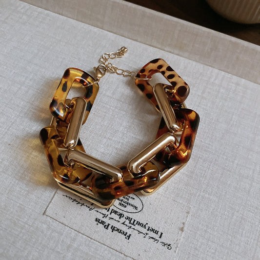 Interlocking rectangular gold/tort bracelet