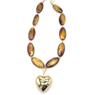Necklace with brown oval beads and a heart-shaped gold pendant on a white background