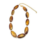 Necklace with brown oval beads on a white background