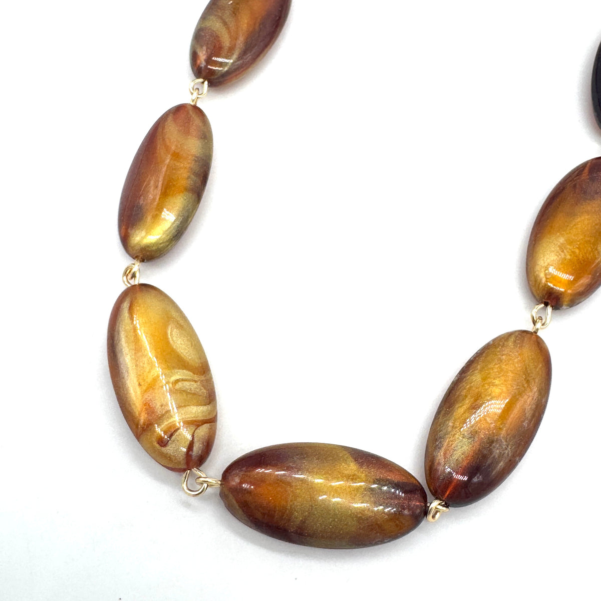 Necklace with brown oval beads on a white background