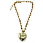 Necklace with heart-shaped pendant and brown beads on a white background
