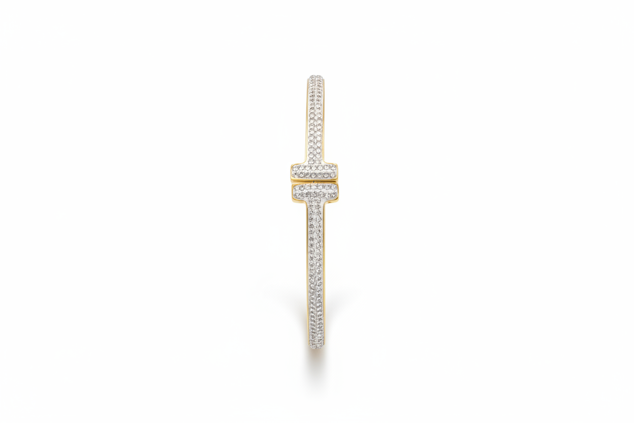 Gold and crystal pavé T-bar bangle bracelet on white background