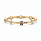 Gold bamboo bangle bracelet with clear crystal stones on white background